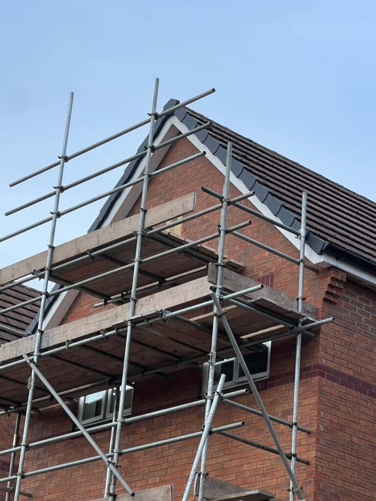 This is a photo of a roof which has just been repaired. There is a scaffold located at the gable end for access onto the roof. Works carried out by Nuneaton Roofing Repairs